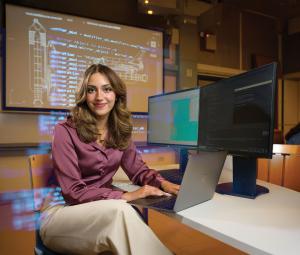 a girly sitting Infront of a computer