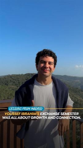 A male is standing in the outdoors in front of trees. Text:Lessons from Madrid. Youssef Ibrahim's Exchange Semester Was All About Growth and Connection.