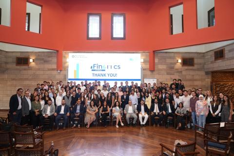 Group photo of males and females in an event. Text on screen: Finomics. Thanks You