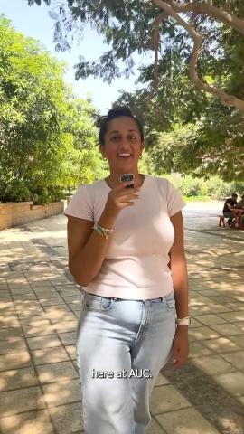 A female is walking into a microphone in a garden