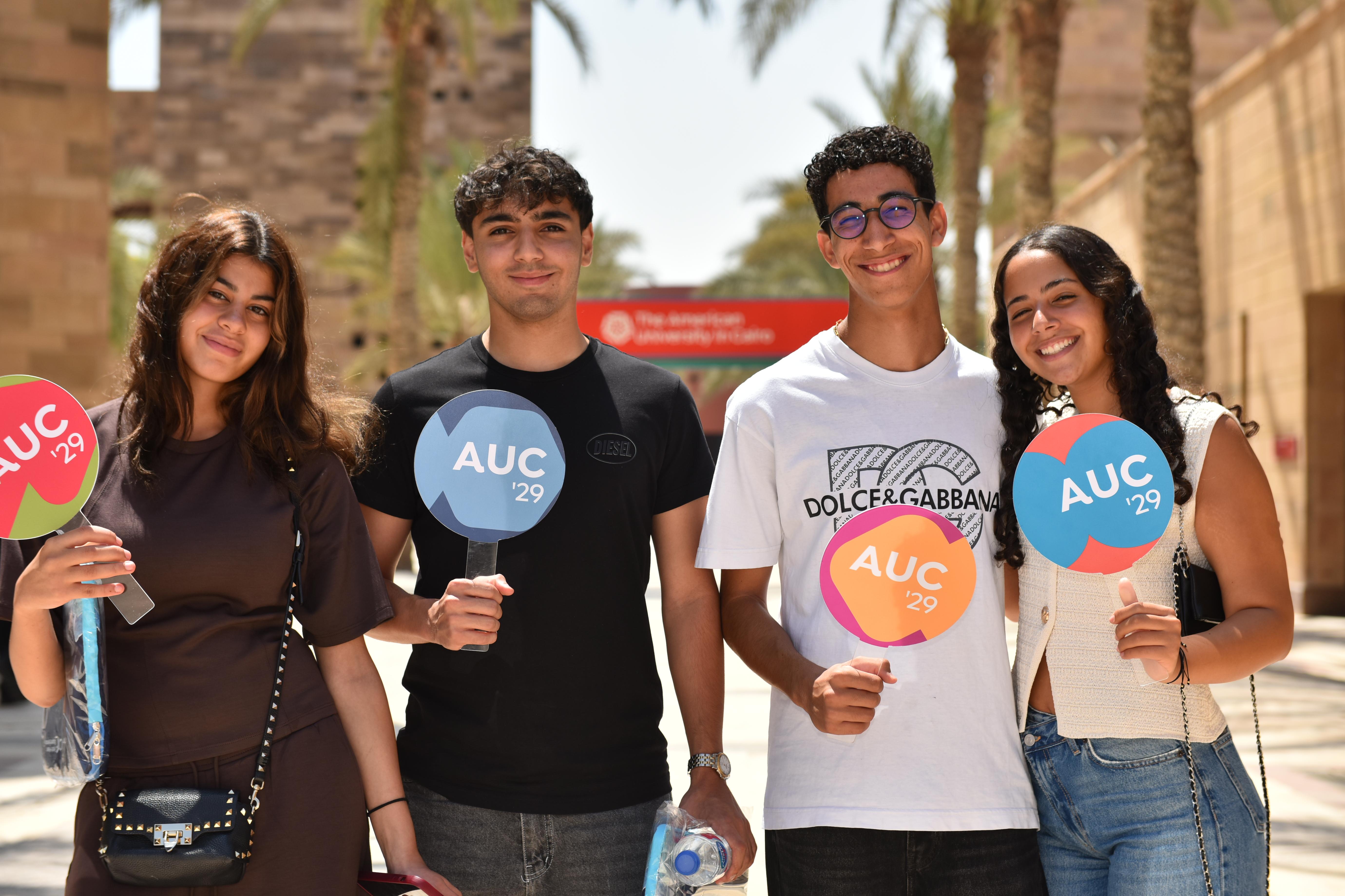 two girls and two boys taking a group photo and smiling