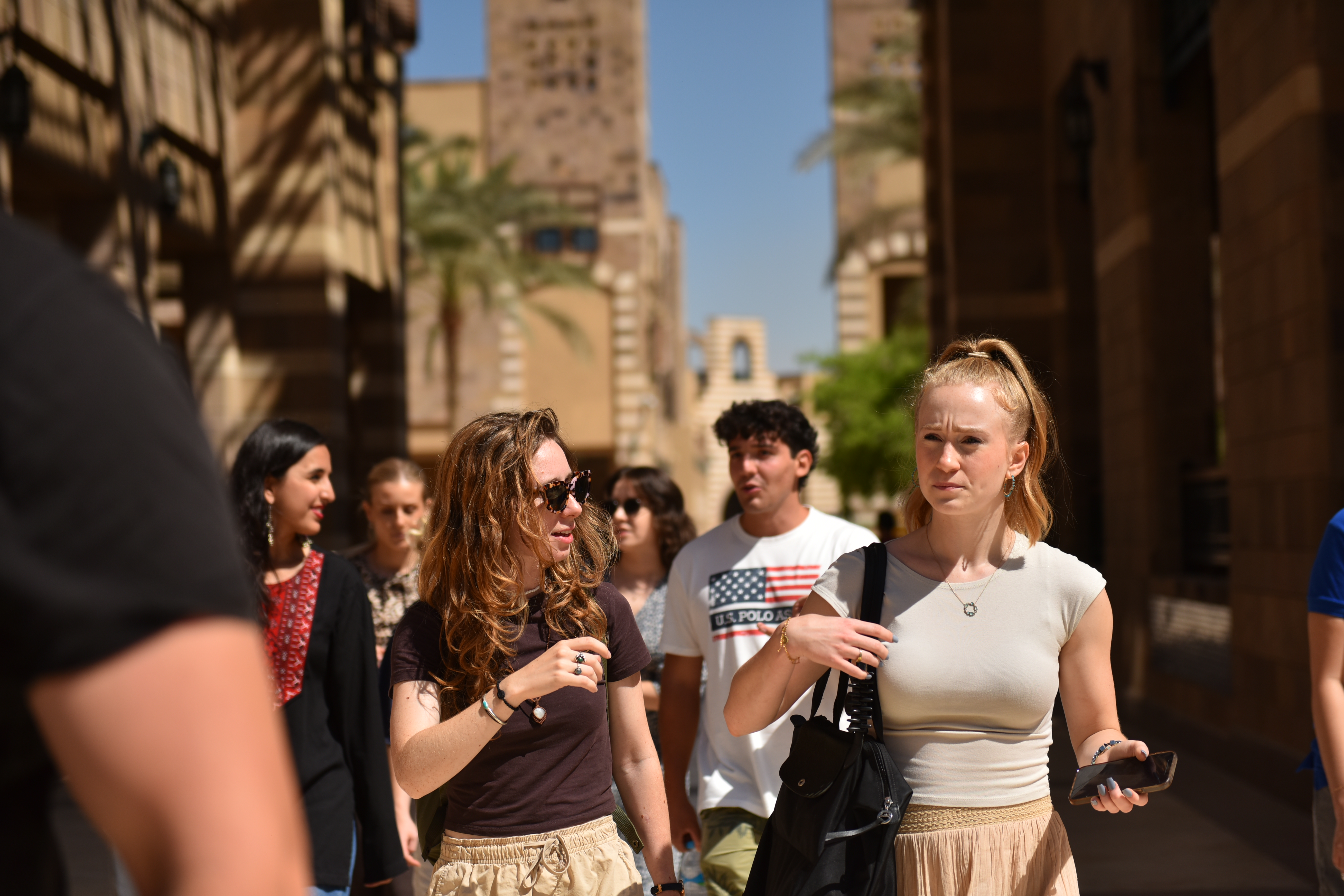 auc international students walking on campus