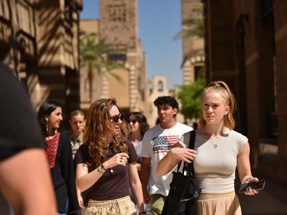 auc international students walking on campus
