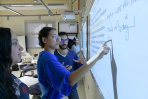 Teaching and Learning Banner image of student writing on white board