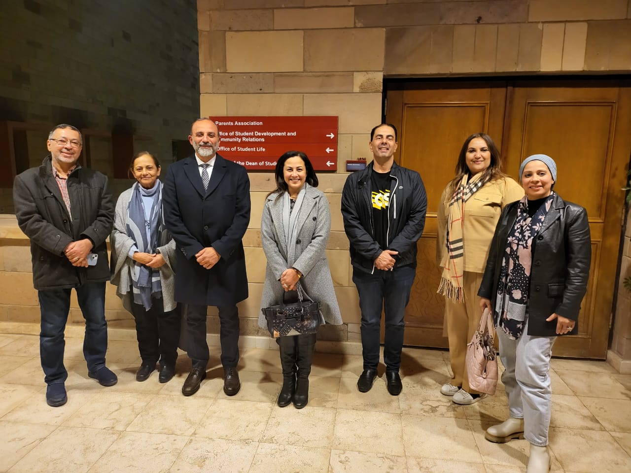 Men and women standing together and smiling