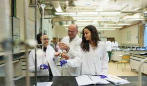 Two students and a professor in the chemistry lab