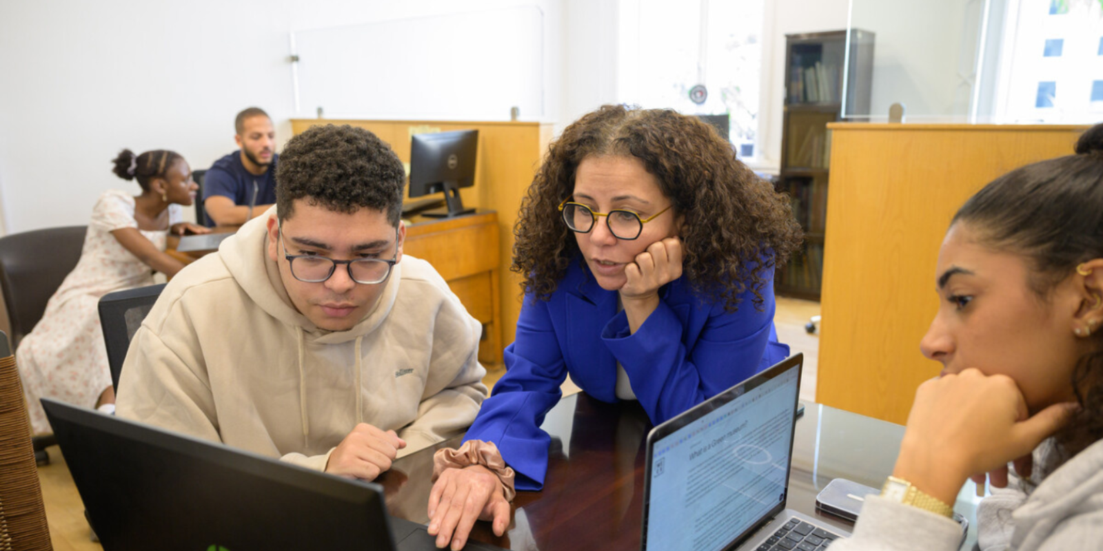 Dr. Rabab helping students at APS