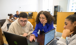 Dr. Rabab helping students at APS